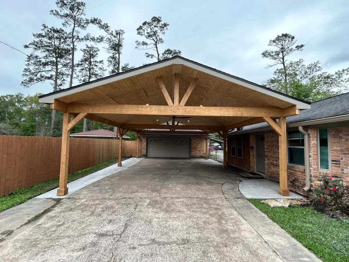 Double-wide timber gable carport attached to a brick house