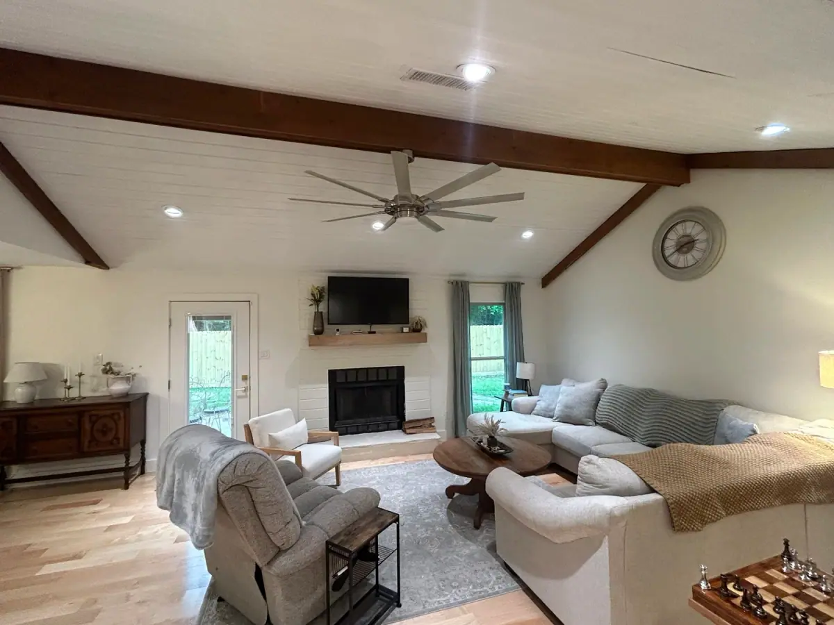 Living room with exposed beams, fireplace and built-ins