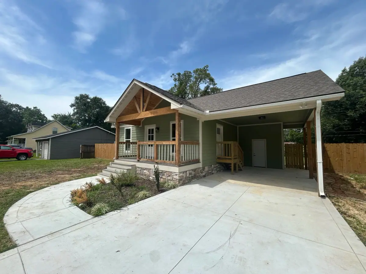 New house with a covered front porch and attached carport