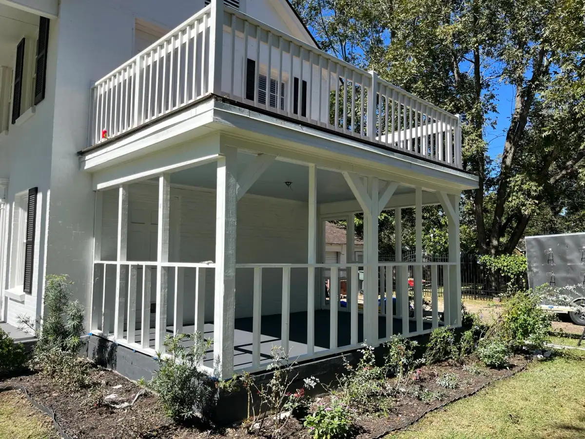Two-story white porch and balcony on a house