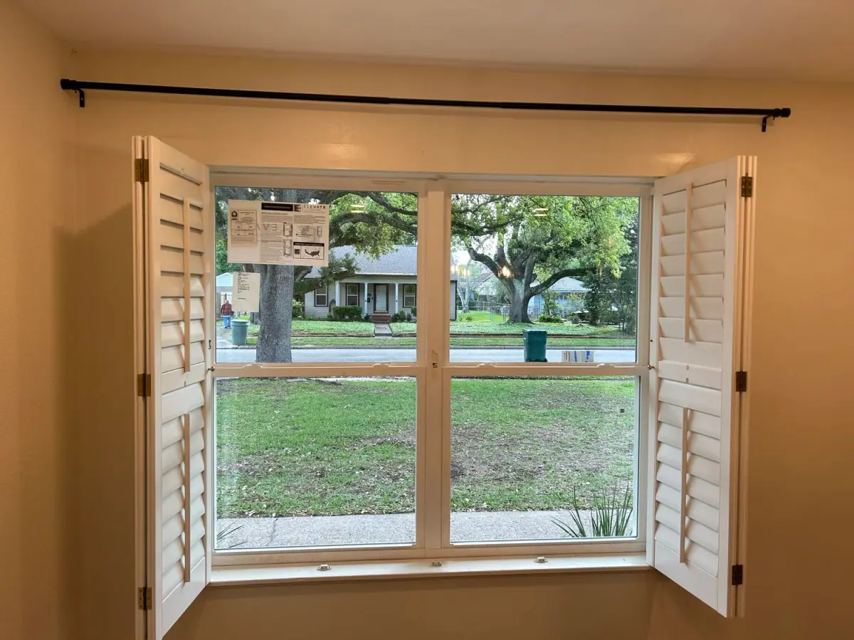 New double-hung window with wood shutters